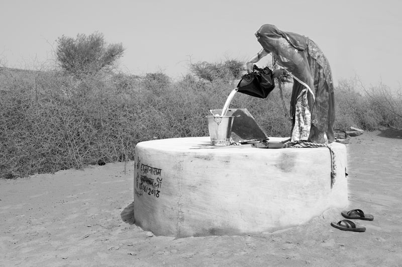 Drinking water being drawn from a small underground tank (kundi) at home - village Binjharwali, Bikaner district, Rajasthan